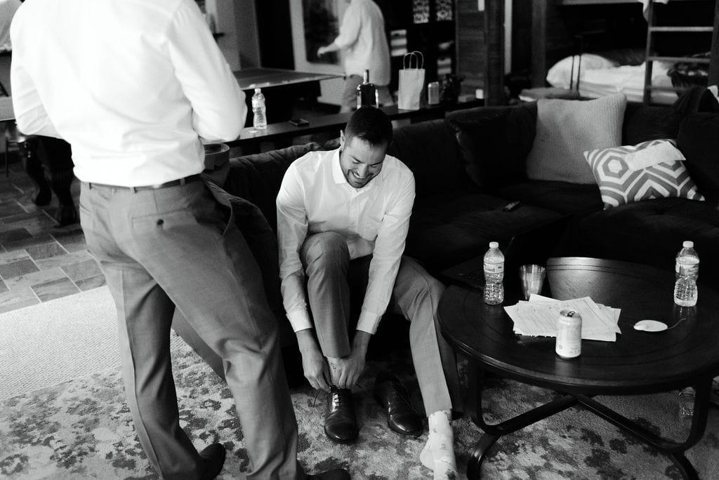Groomsmen putting on shoes
