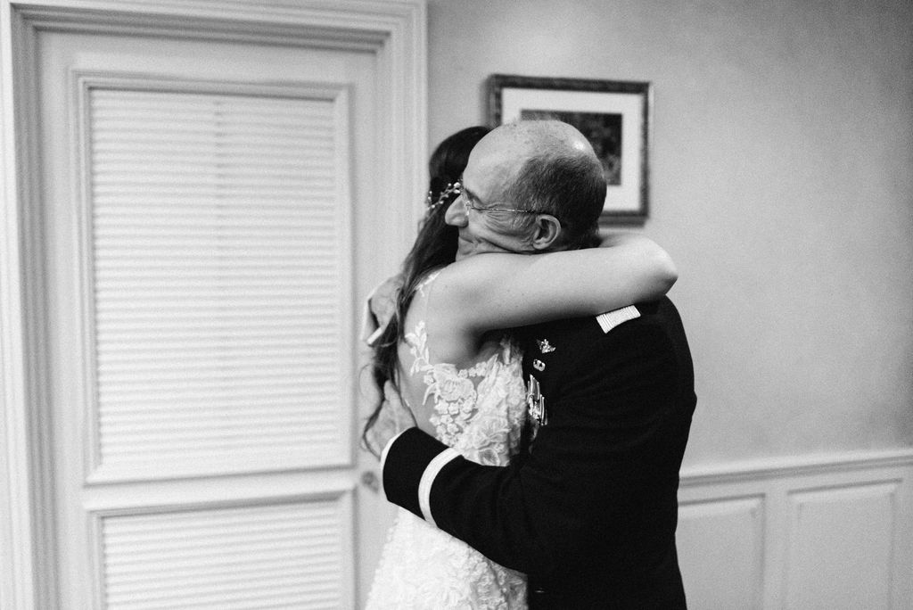 father of the bride sees his daughter for the first time in her wedding dress