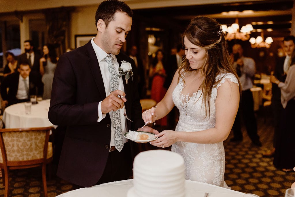 Bride and Groom cut the cake at Cheyenne Mountain Country Club Wedding Reception