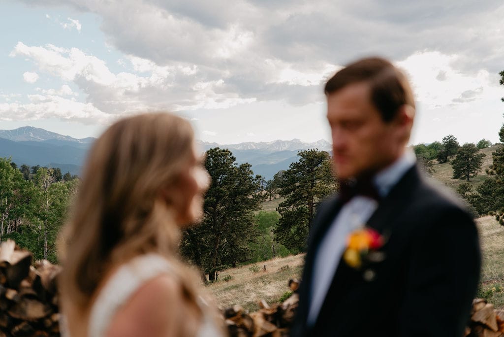 Artsy photo of bride and groom with mountains in the background