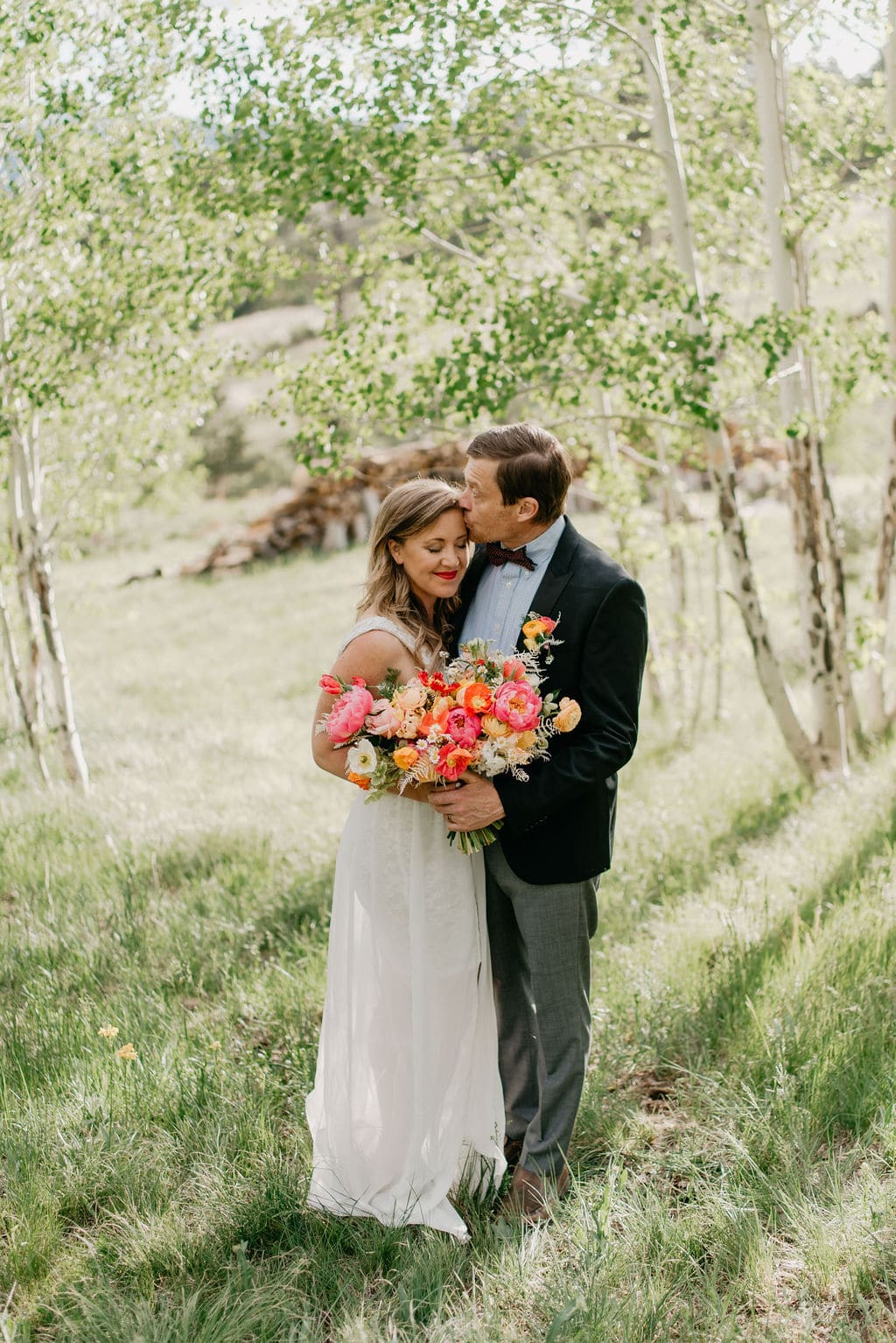 Romantic bride and groom portraits in golden colorado aspen grove