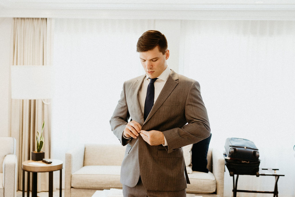 Groom getting ready at The Little Nell Hotel in Aspen Colorado