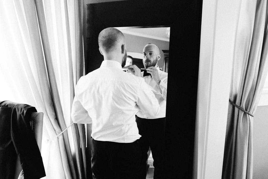 Groom gets ready for his littleton colorado wedding at the manor house