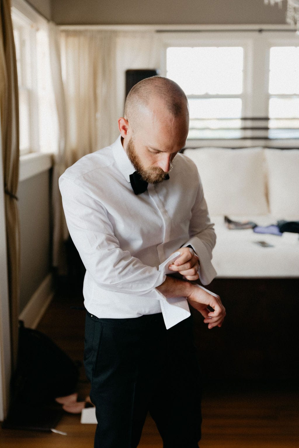 Groom gets ready for his littleton colorado wedding at the manor house