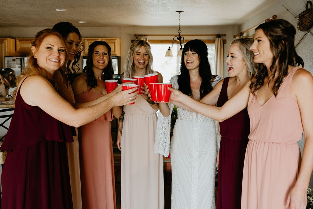 Bride taking shots with her bridesmaids after getting ready