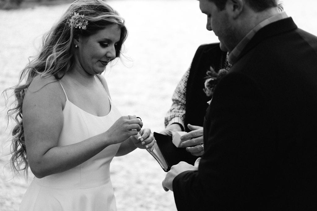 Bride and groom exchange rings at their sprague lake elopement