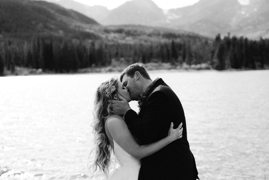 Bride and grooms first kiss at their rocky mountain national park elopement
