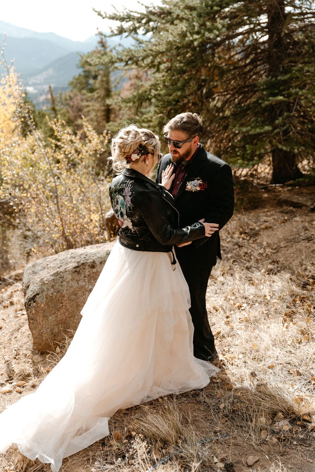 Bride and groom kiss before their estes park elopement at their first look