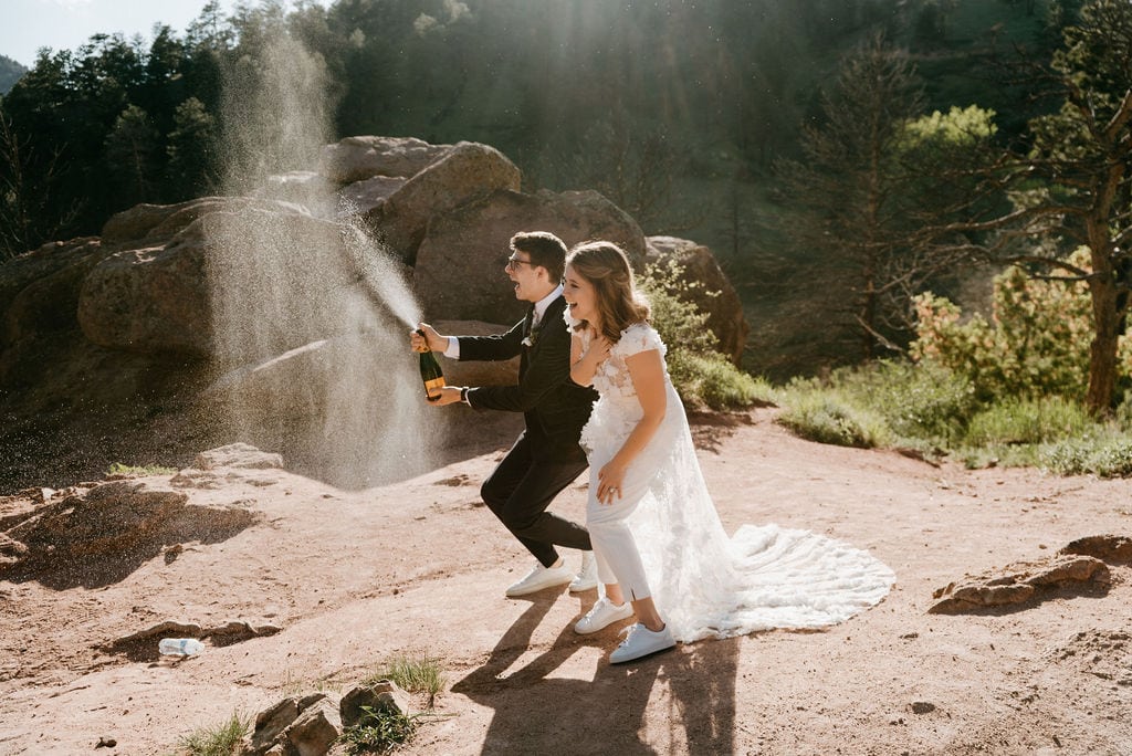 Popping Champagne at Boulder Colorado Elopement at Settlers Park at Sunset