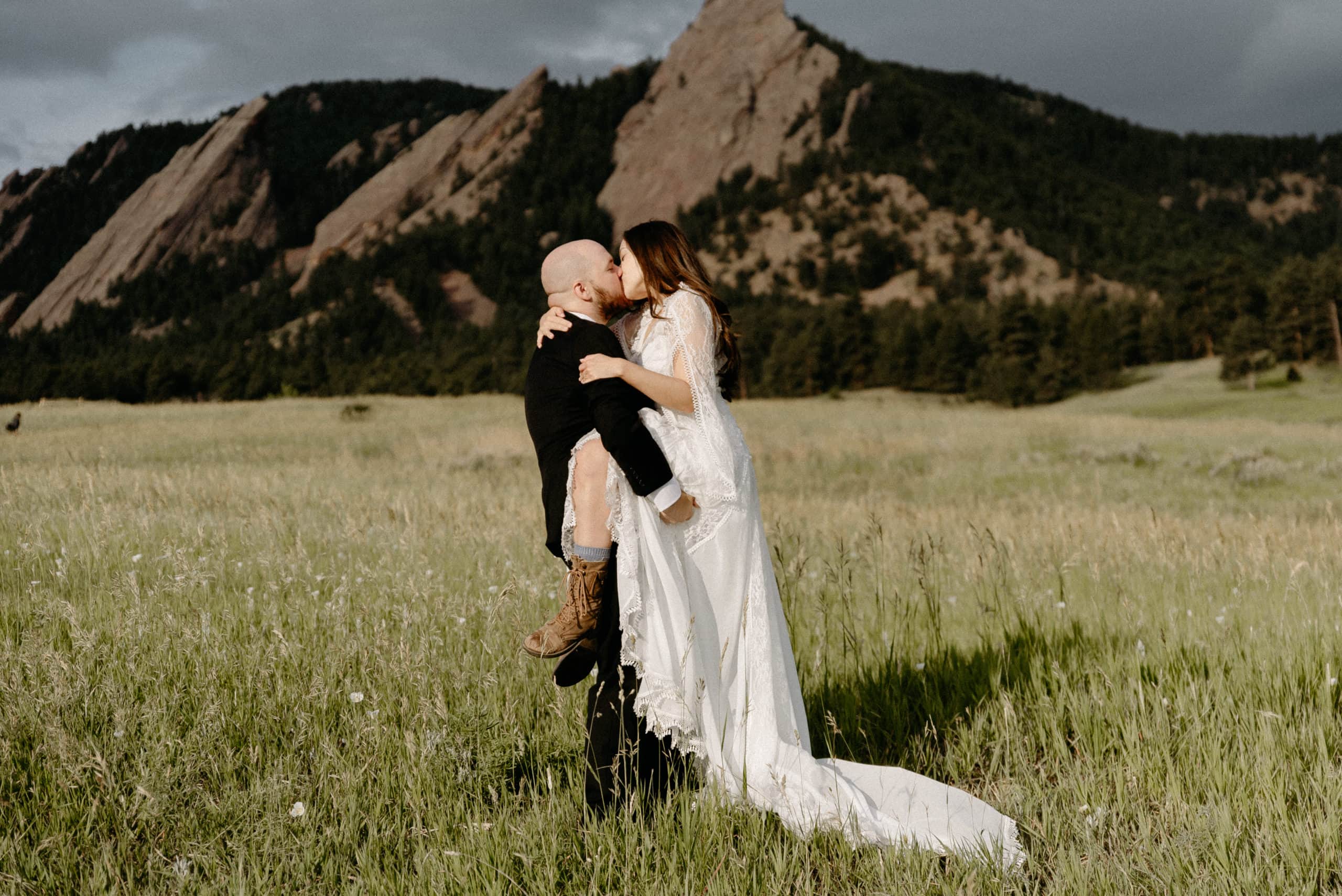 Bride jumps into grooms arms at Chautauqua Park elopement Location in Boulder