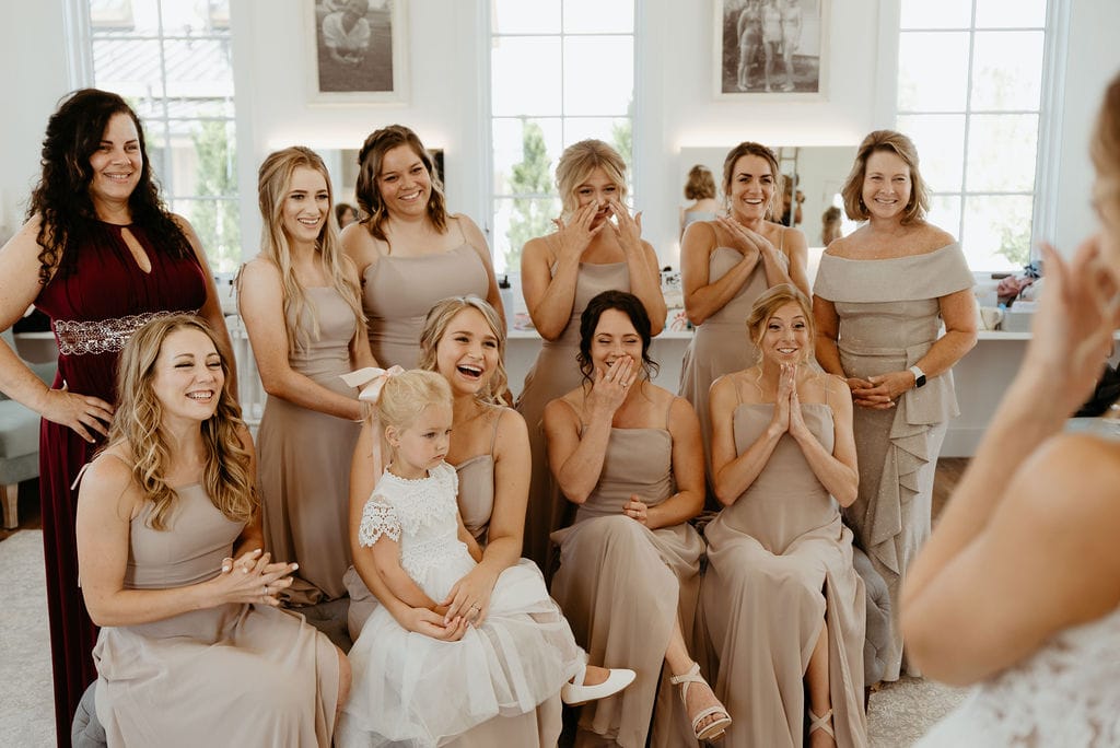 Bridesmaids see bride in her dress for the first time