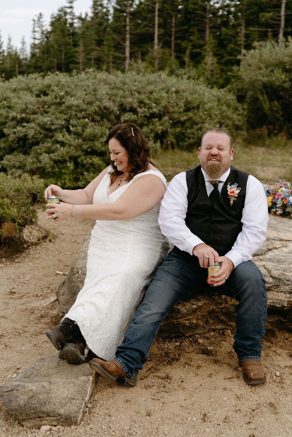 Bride and groom eat cookies and have a picnic at brainard lake