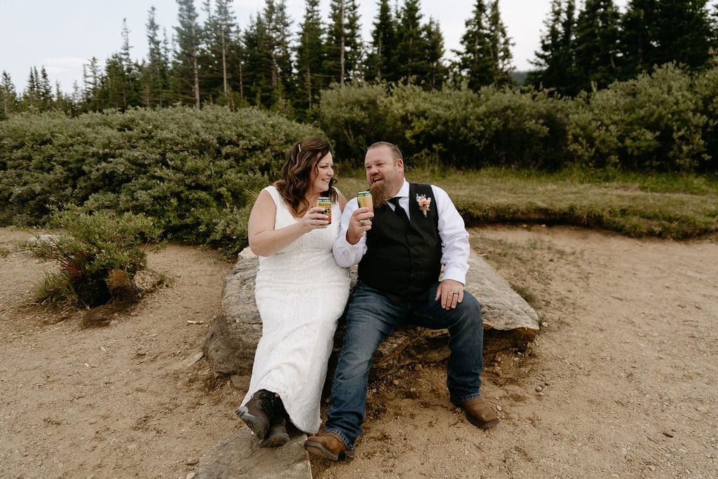 Couple toasts their favorite beers at the brainard lake elopement