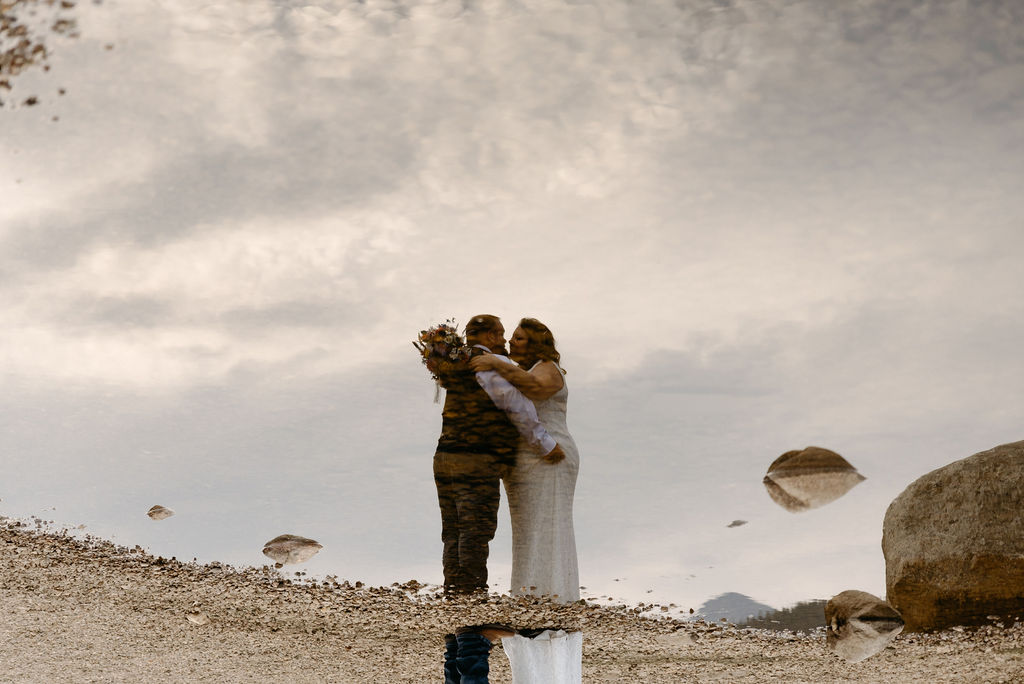reflection of wedding couple in brainard lake