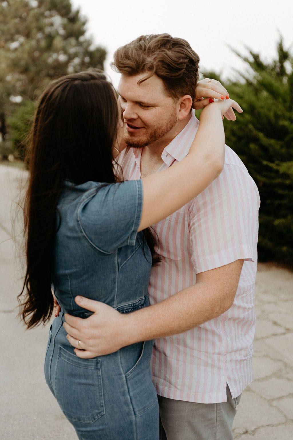 Couple kisses outside of Bowlero during their bowling engagement session