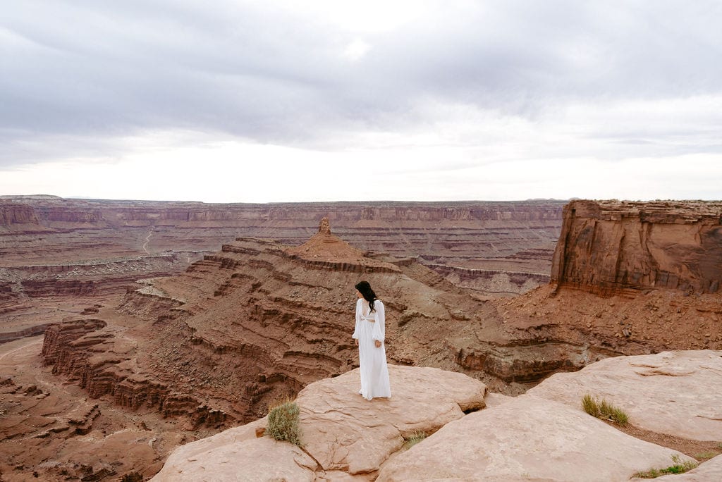 Bride waits for her groom to join her before saying vows at their moab elopement at dead horse point state park