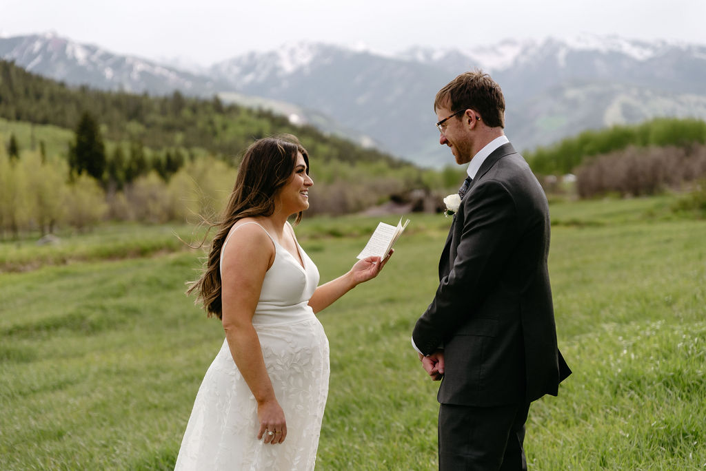 Couple laughs at their Aspen elopement as she reads her vows