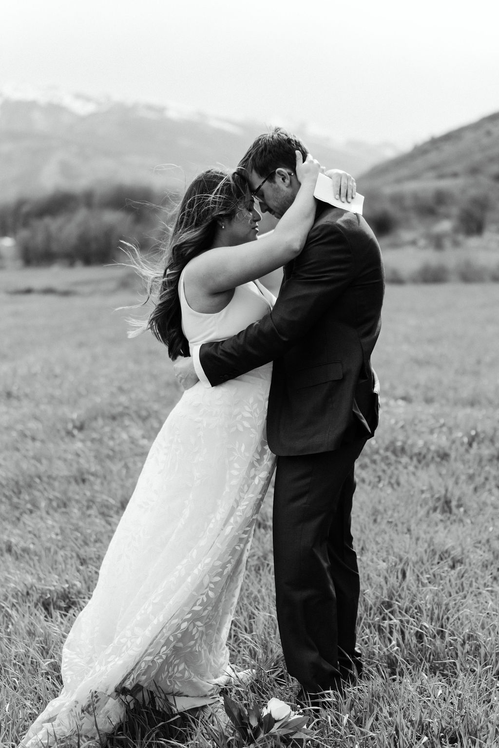 Couple embraces each other at their Aspen elopement as they read vows