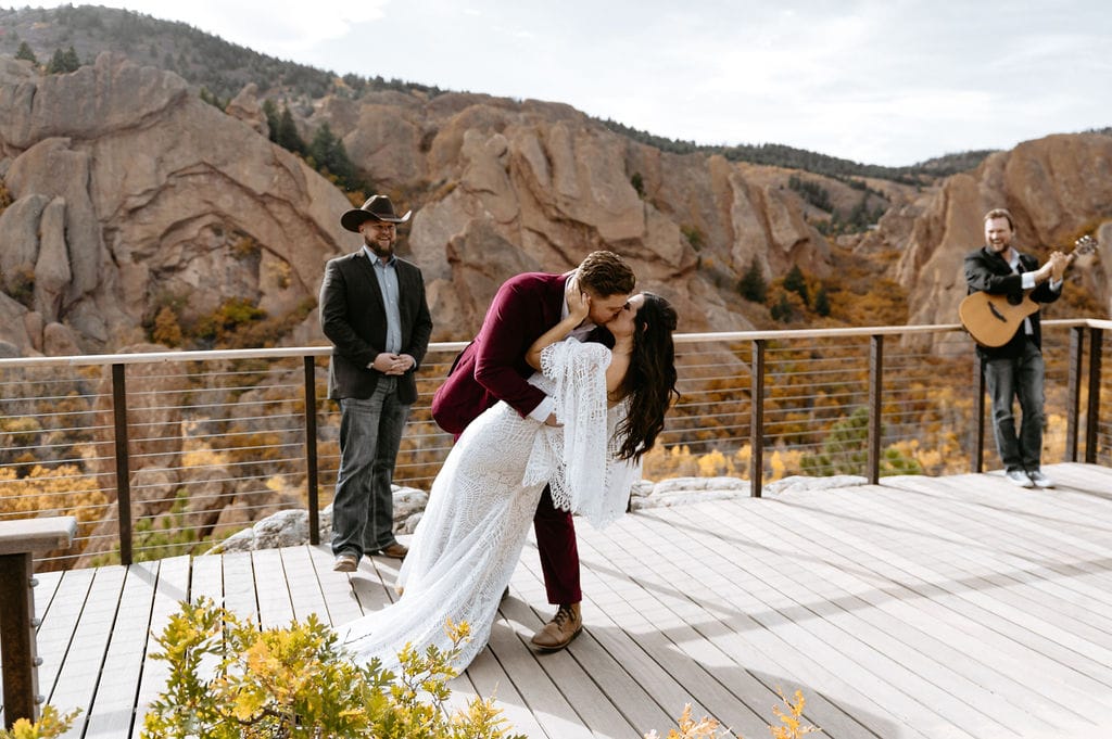 Couple shares first kiss at their Overlook Wedding at Roxborough State Park