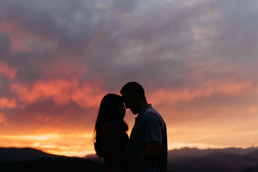 Couple in front of a gorgeous Boulder Sunset at their engagement session