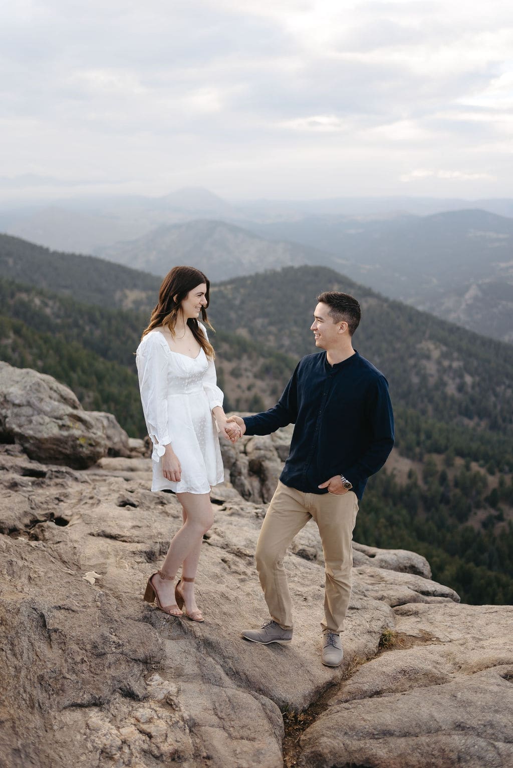 Fall Engagement Session at Lost Gulch in Boulder on top of Flagstaff Mountain. Couple holds hands