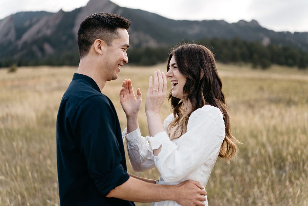 Cute laughter at boulder engagement session