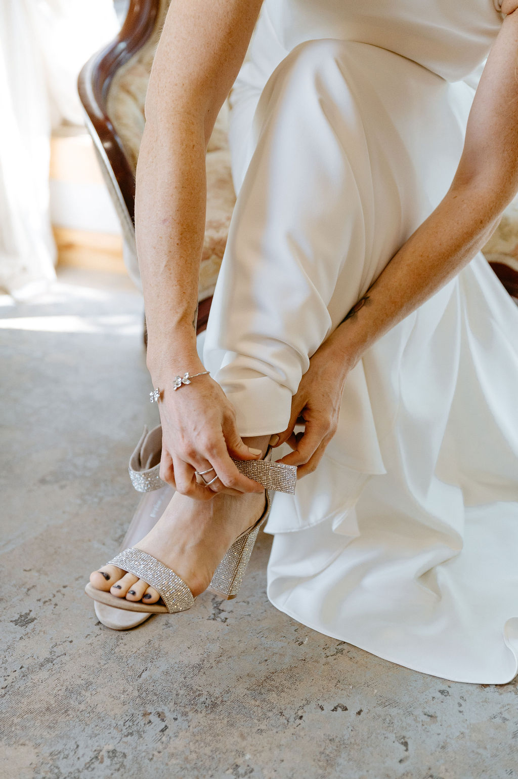 Bride gets her dress and shoes on for her wedding at river bend in colorado