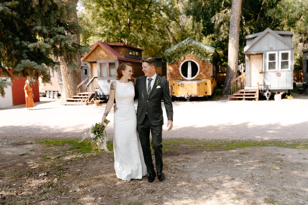 Wedding day portraits in lyons colorado at the river bend with tiny homes in background