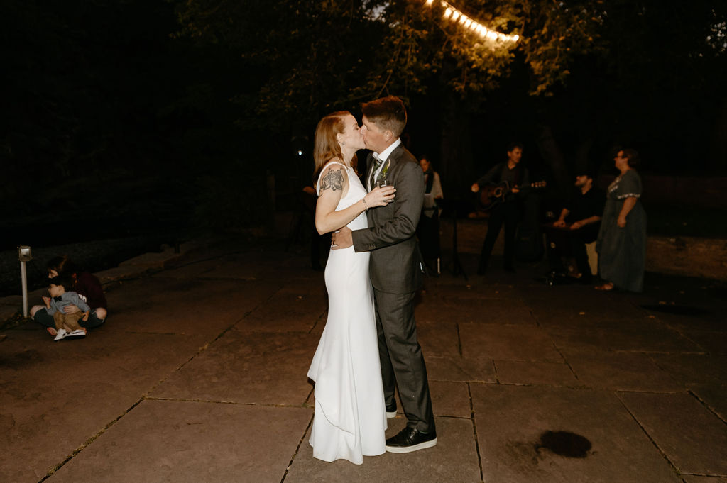 first dance under the string lights at the river bend wedding venue in lyons, colorado