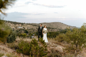 Gorgeous wedding day portraits taken on top of a cliff in colorado near river bend wedding venue