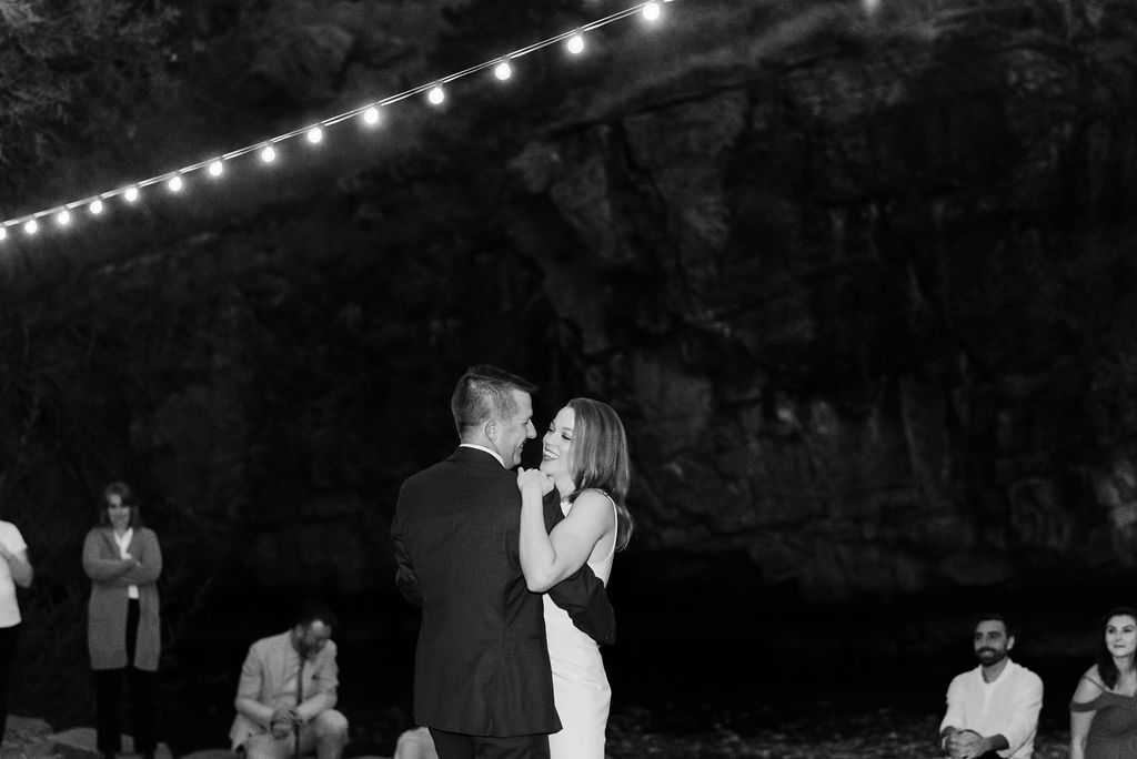 First dance photos at river bend in colorado under the string lights