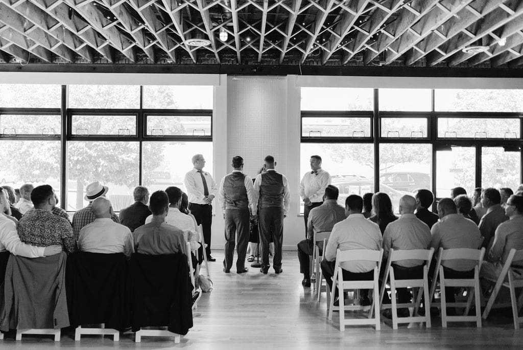 Two grooms get married at Wash Park Studio near Denver Colorado at an Indoor urban ceremony 