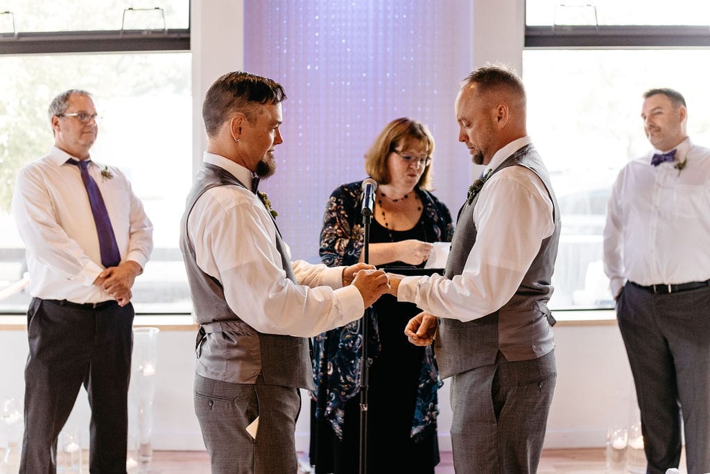 Gay Couple Exchange wedding rings at their Denver Colorado LGBTQ Wedding at Wash Park Studio 