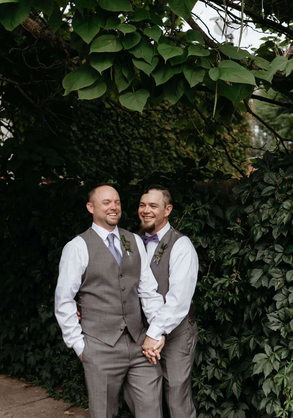 Gay Couple Laughs during LGBTQ Wedding Portraits Outside in Wash Park Neighborhood of Denver