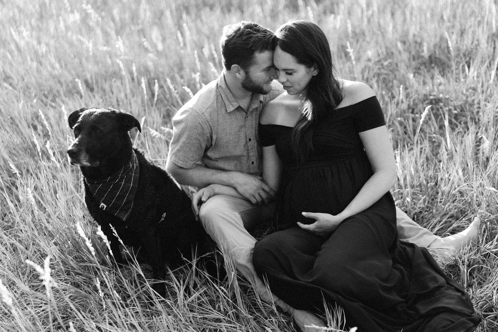 A Couples Romantic Denver Maternity Photos with there dog at Lair o the Bear Park