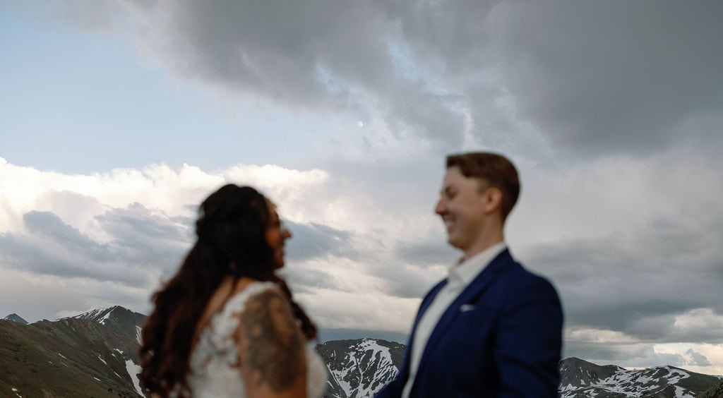 Colorado Wedding Photographer captures the moon behind their couple on Loveland pass