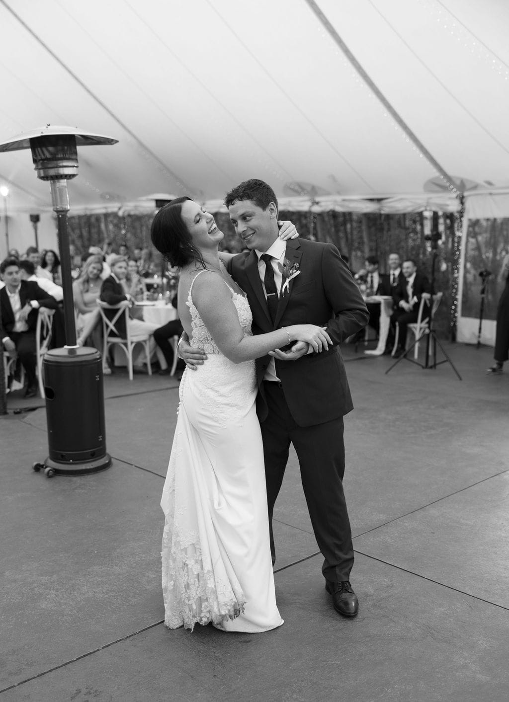 Couple laughs during their First dance photos at blackstone rivers ranch wedding