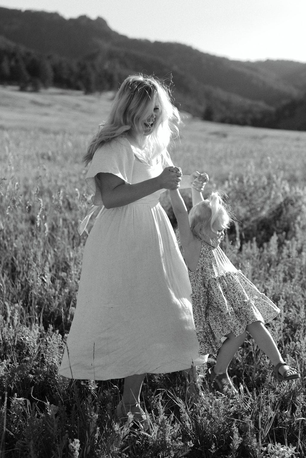 Mom and daughter playing at chautauqua park during their family session