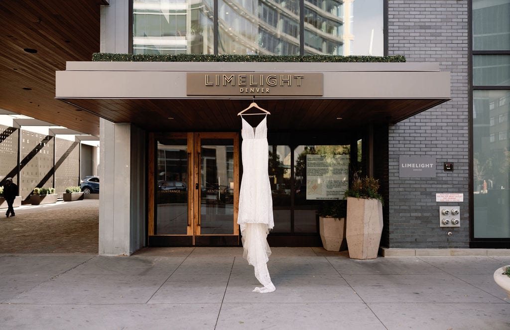 Gorgeous wedding dress hangs at limelight hotel in Denver Colorado
