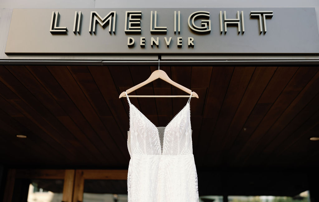 Gorgeous wedding dress hangs at limelight hotel in Denver Colorado