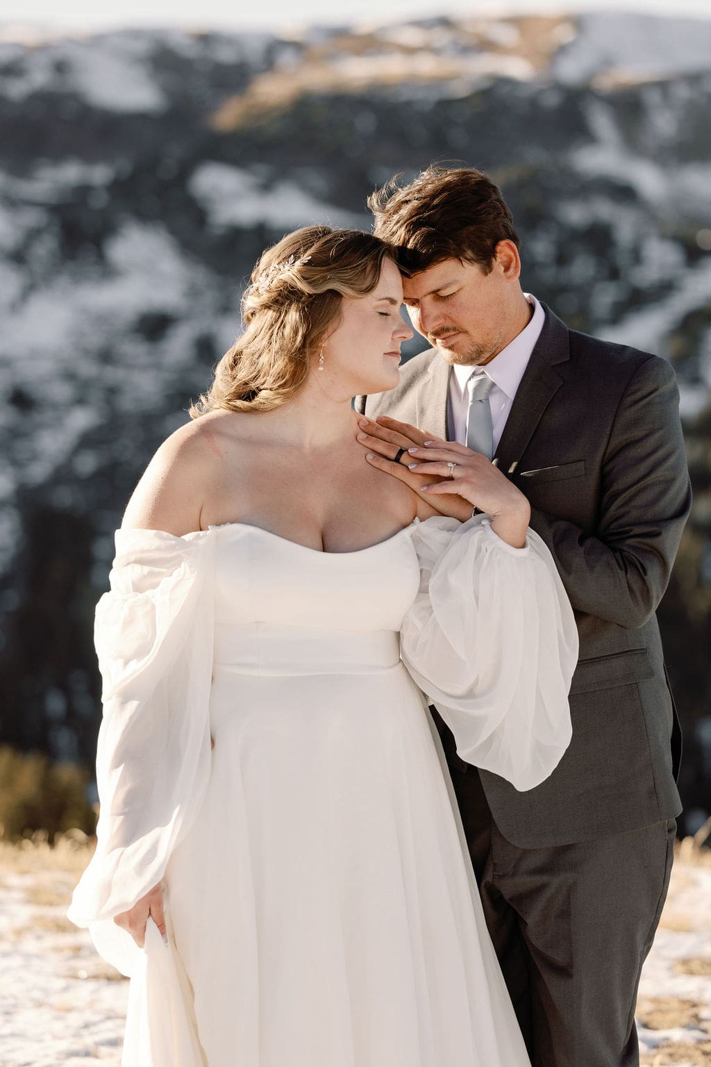 Romantic portraits of a bride and groom on loveland pass in colorado after eloping with close friends and family