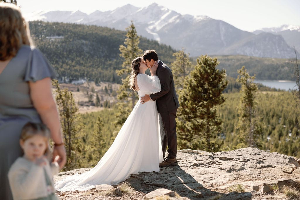 First kiss as husband and wife at an overlook in breckenridge colorado