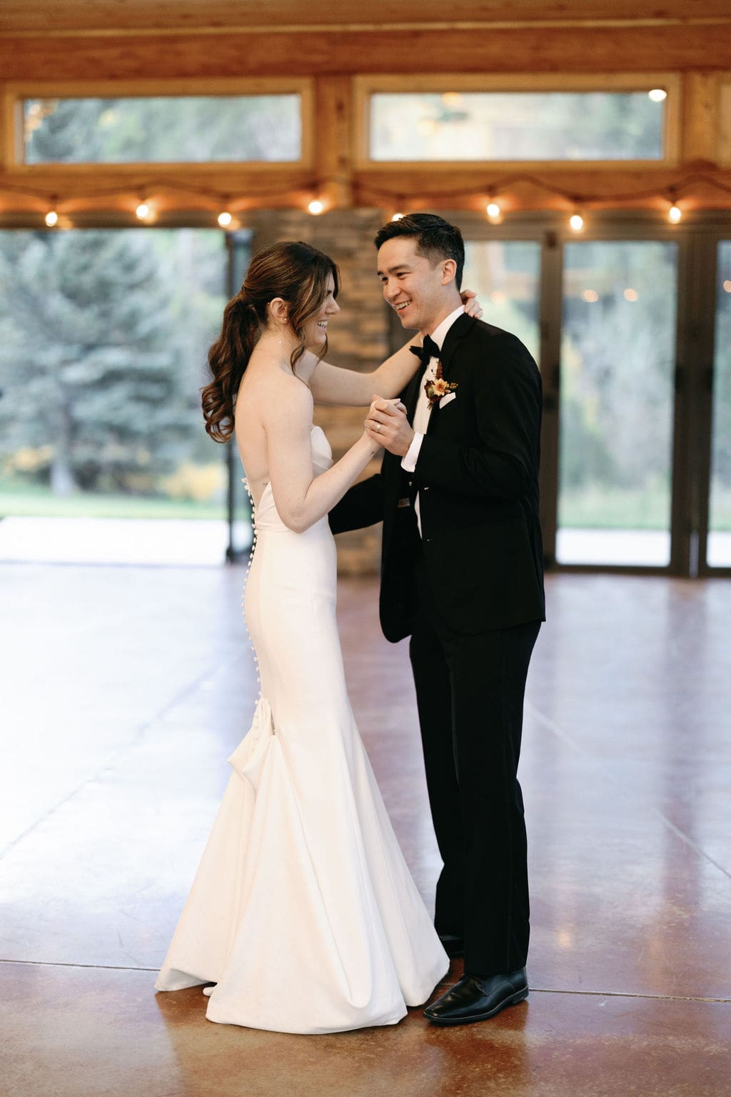 Couples first dance to A cover of blink 182s First Date by Taylor Acorn. Romantic dancing at mt princeton hot springs on the dance floor of wedding reception