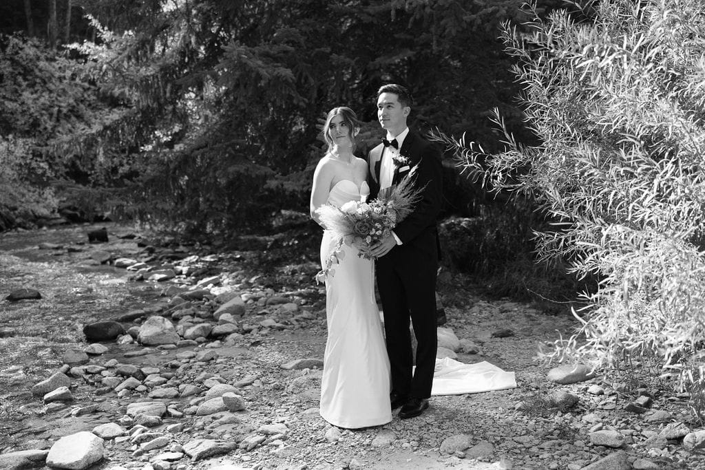 Sweet bride and groom portraits by the river near their Mount Princeton Hot Springs Wedding Venue in Buena Vista, Colorado