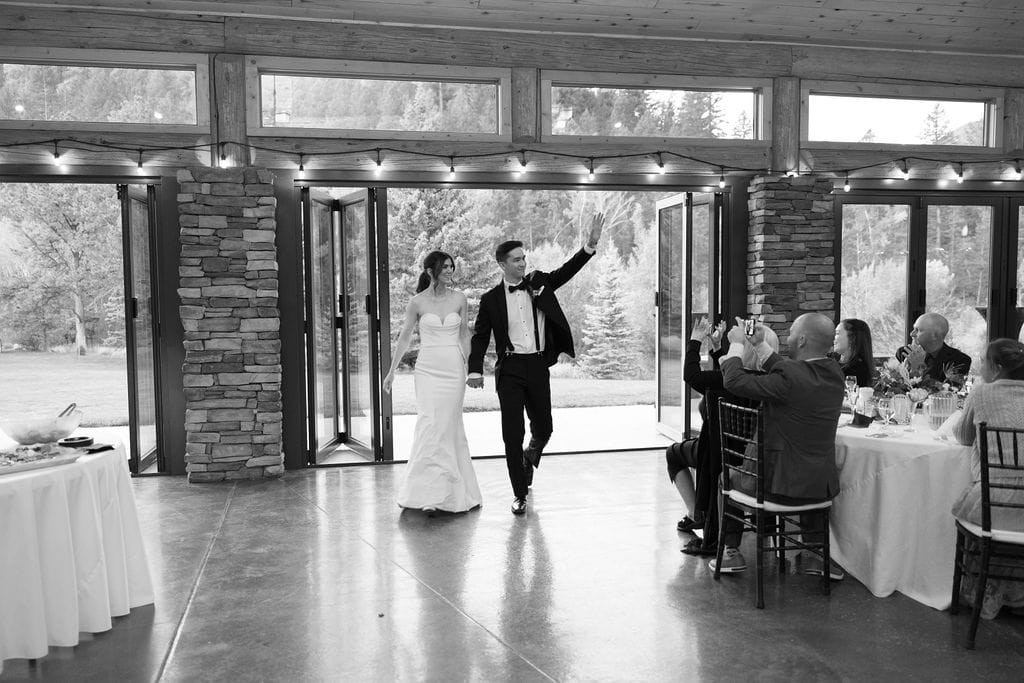 Bride and Groom enter their wedding reception held at mt princeton hot springs pavilion