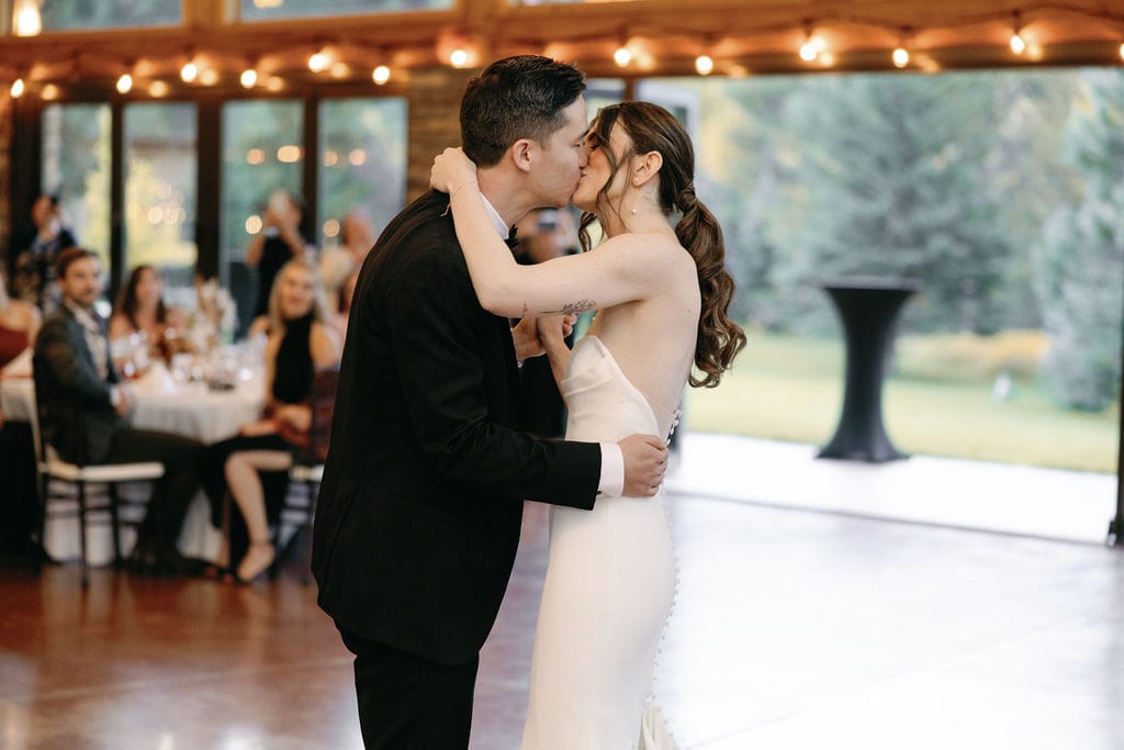 Couples first dance to A cover of blink 182s First Date by Taylor Acorn. Romantic dancing at mt princeton hot springs on the dance floor of wedding reception