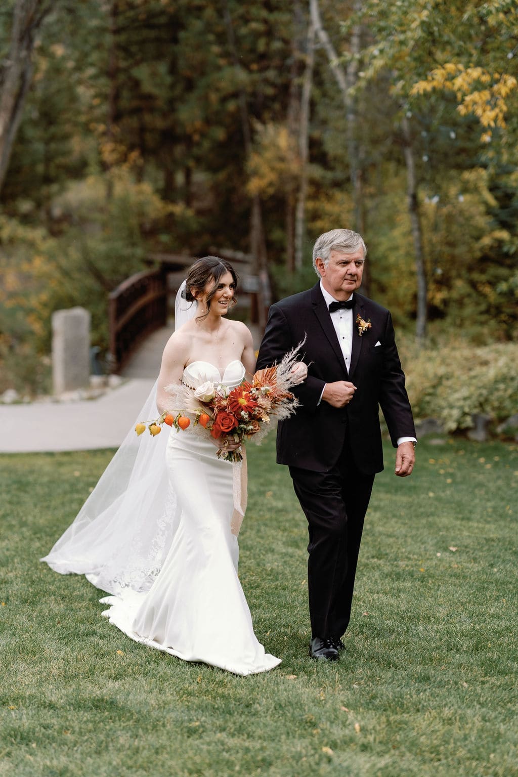 Bride and father walk down the aisle at mount princeton hot springs wedding