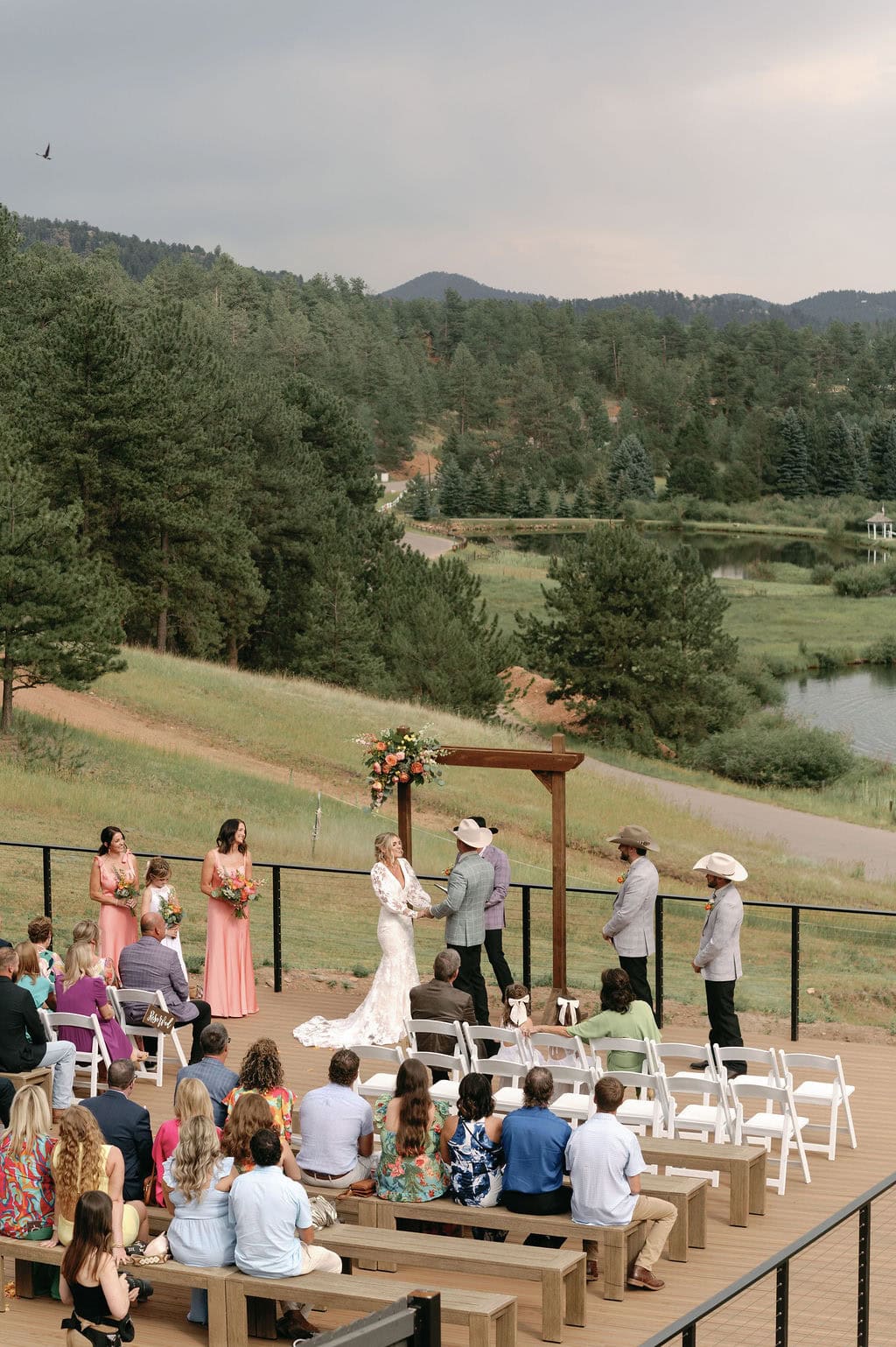 dreamy lakeside wedding ceremony at Mountain view ranch lakeview in pine colorado, with country chic vibes on a cloudy day.