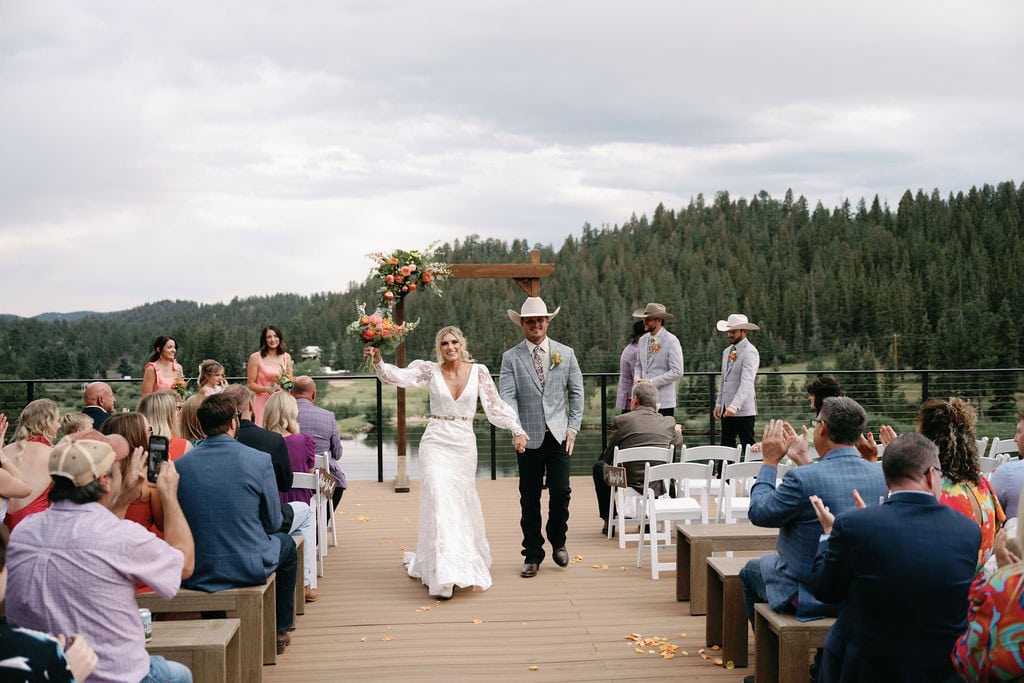 dreamy lakeside wedding ceremony at Mountain view ranch lakeview in pine colorado, with country chic vibes on a cloudy day.