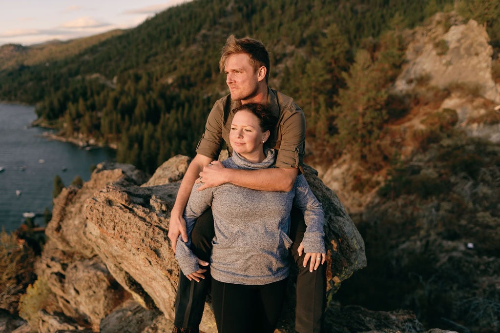South Lake Tahoe Engagement Photos at Cave Rock at sunset in the fall. Couple looks out over the lake